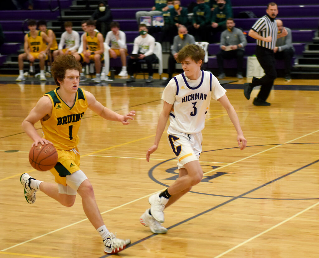 Rock Bridge's Hudson Dercher runs the ball up the court